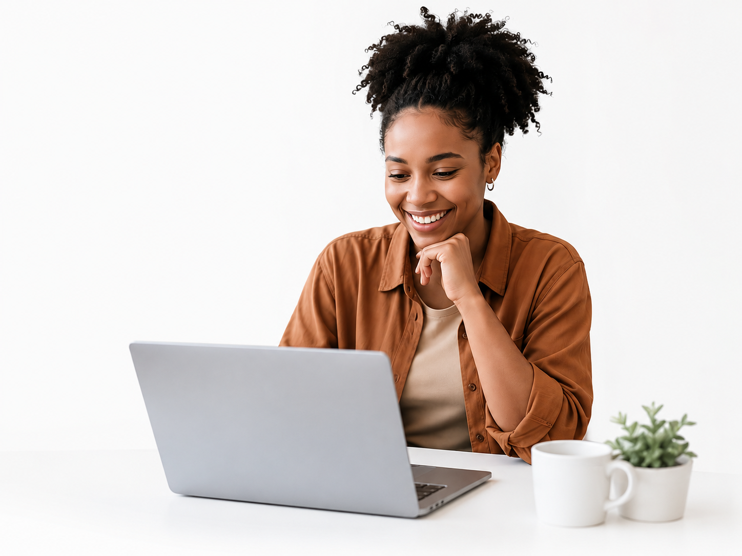 A candidate smiling at interview invitations on her laptop